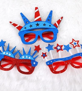 Macro shot of glitter-coated Independence Day party glasses with stars and stripes details