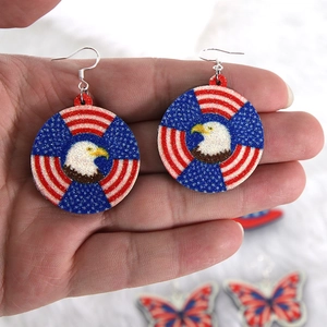 American flag round earrings featuring a bald eagle design with red white and blue glitter