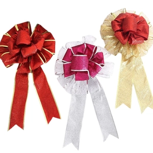 Three festive Christmas bows with glitter gold mesh and pink ribbons for holiday decor