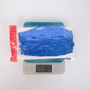 Detailed view of ocean blue foil fringe curtain packaging weighing 72.7 grams