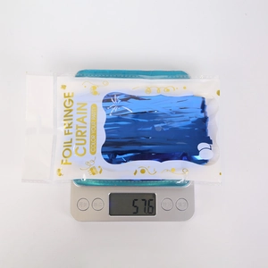 Detailed view of ocean blue foil fringe curtain packaging and product weight measurement