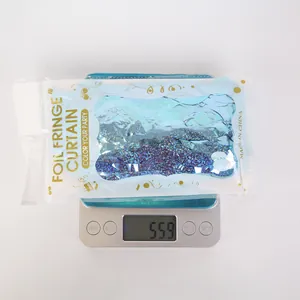 Close-up of laser blue party fringe curtain weighing 55.9g on a digital scale