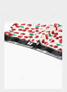 Close-up of men's ice silk boxer shorts with cherry print and elastic waistband