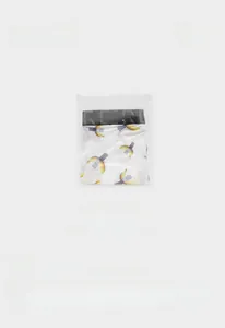 Mens white boxer briefs with banana patterns in a clear sealed retail polybag packaging