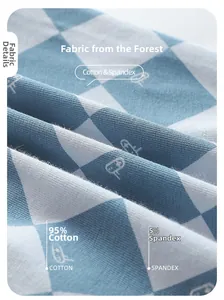 Detail of soft 95% cotton knit fabric with blue grid pattern and small mouse print