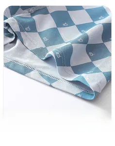 Detailed close-up of blue checkerboard cotton boxers showing fine rib knit and precision stitching