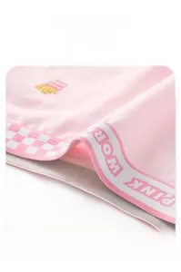 Close-up of pink cotton panties featuring a PINK WORLD elastic waistband and embroidery
