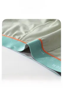 Detail of breathable men's cotton boxers with elastic waistband and orange stitching