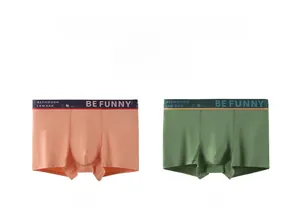 Detail view of men's cotton boxer briefs in shrimp orange and dark green with waistband text
