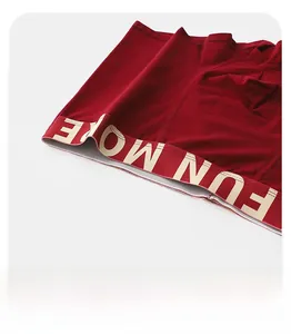 Detail view of the deep red men boxers showing the wide elastic waist with FUN MORE text