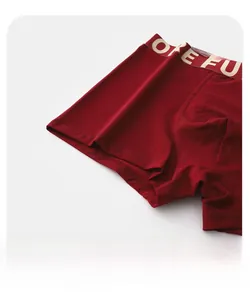 Detail of red boxer briefs featuring elastic waistband and smooth flat-stitched leg cuffs