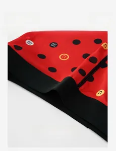 Macro detail of men's red ice silk boxer briefs featuring elastic black waistband