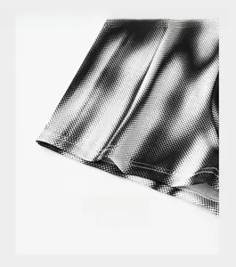 Close-up of reinforced trouser cuffs featuring black and white gradient dot texture pattern