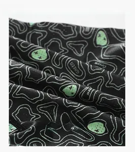 Macro shot of breathable ice silk fabric with green avocado prints for men underwear