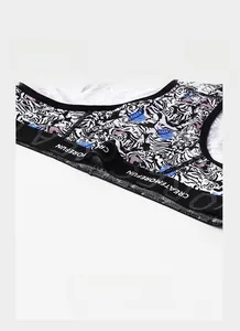 Detailed view of elastic waistband with white text and tiger print men boxer fabric