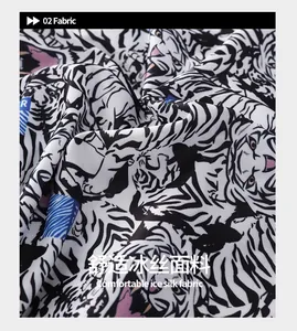 Close-up of cooling ice silk fabric featuring white tiger print and blue geometric shapes