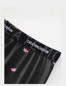 Close-up of lightweight elastic waistband with white lettering on black boxer shorts