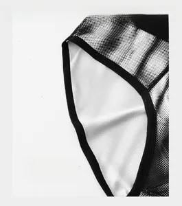 Detail of reinforced cuffs and breathable mesh fabric on men's boxer briefs with dot pattern