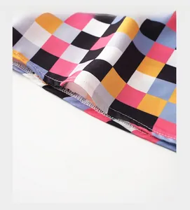 Detail of reinforced trouser cuffs with plaid pattern and high-density stitching