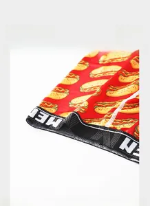 Detail of red men's boxer briefs with hot dog print and black elastic waistband