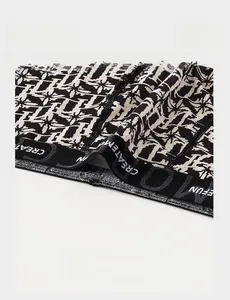 Detail showing the lightweight black elastic waistband with woven brand lettering texture