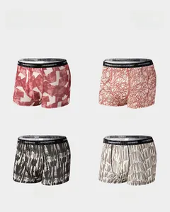 Macro display of four printed ice silk men boxer briefs with elastic letter waistbands