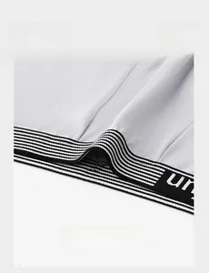 Detail of white men's underwear featuring a flexible black and white striped elastic waistband