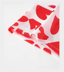 Close-up of white men's boxers with red heart prints and reinforced trouser cuffs