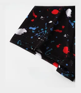 Close-up of ice silk underwear reinforced trouser cuffs with vibrant splash paint patterns