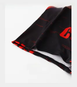 Close-up of reinforced trouser cuffs with red fashion letter printing on black fabric