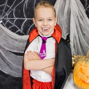 Kids purple glitter Halloween tie with ghost and witch hat motifs for party dress-up
