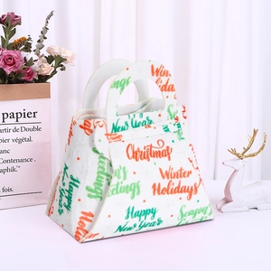 Felt Christmas gift bag with festive typography and handle on white background