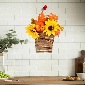 Detail of hanging wicker flower basket with autumn sunflowers and maple leaves decor