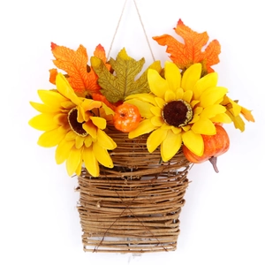 Hanging wicker basket with sunflowers and autumn maple leaves for wall decoration