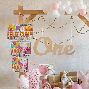 Close-up of three-tier silver foil fringe birthday banner with Feliz Cumpleaños print