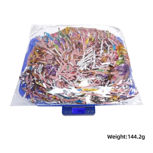 Detailed view of colorful metallic party confetti weighing 144.2g on a scale