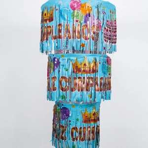 Detail of blue foil fringe banner with Feliz Cumpleaños text and festive party elements