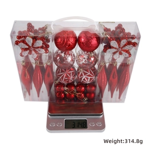 Detailed set of red Christmas tree ornaments in a transparent gift box weighed on a scale