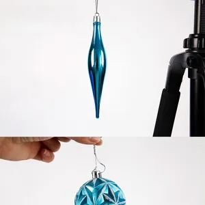 Detailed view of shiny blue Christmas ornaments with star textures and glitter finish