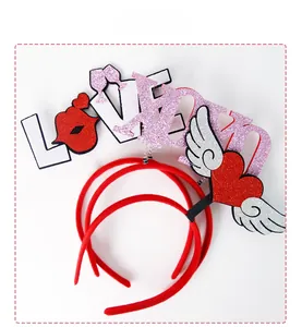 Close-up of glittery LOVE letters and winged heart icons on red party headbands