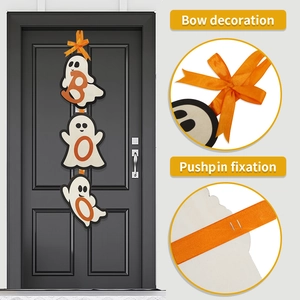 Close-up of Halloween ghost wooden hanging sign with orange bow and pushpin fixation