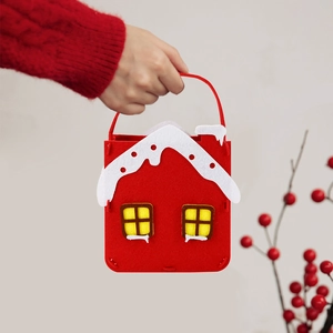 Red felt Christmas gift bag shaped like a house with handle for holiday candy storage