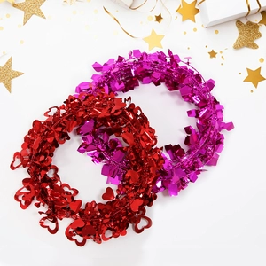 Romantic red and magenta heart-shaped tinsel wreaths for Valentine's day wedding decoration