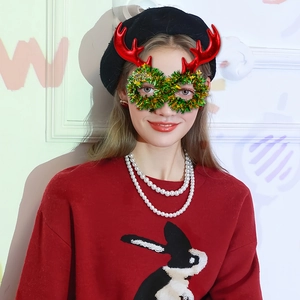 Christmas reindeer glasses with red antlers and Merry Christmas wreath for holiday parties