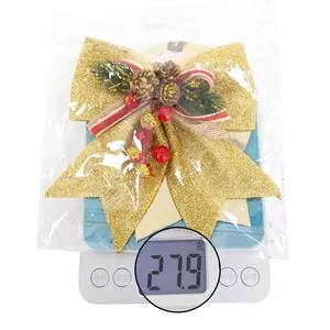 Detailed close-up showing a 27.9g large Christmas bow ornament with pine cones and berries