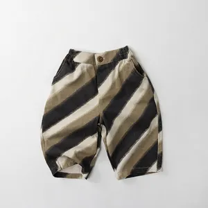 Detail of children striped cotton linen shorts showing fabric texture and button closure