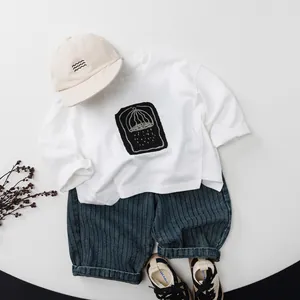 Kids casual outfit with striped denim joggers, white t-shirt, beige cap and panda sneakers