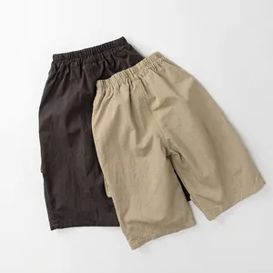 Kids loose casual cotton linen shorts in brown and beige colors with elastic waist
