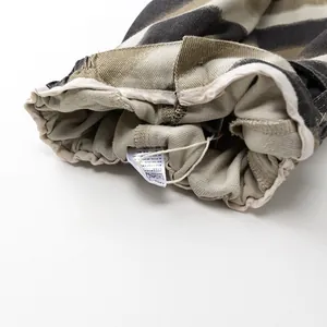 Detail of children striped pants showing elastic waistband and fabric laundry label
