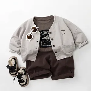 Three-piece casual kids outfit with gray apple cardigan, brown tee and matching shorts